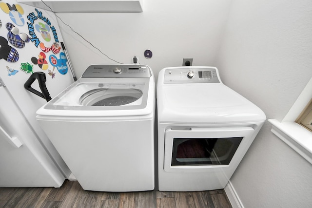 laundry room featuring washer and dryer, laundry area, and wood finished floors