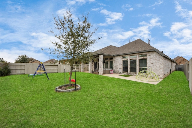 back of property featuring a patio area, a yard, a fenced backyard, and brick siding