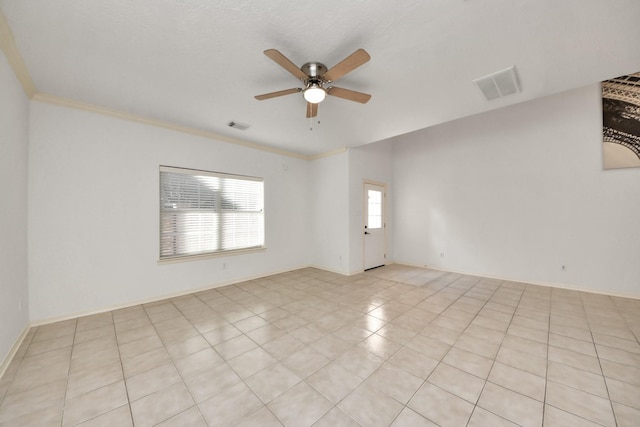 empty room featuring crown molding, visible vents, and ceiling fan