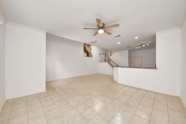 unfurnished living room featuring baseboards, a ceiling fan, stairs, a textured ceiling, and crown molding