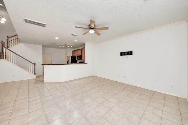 unfurnished living room featuring a textured ceiling, visible vents, a ceiling fan, stairs, and ornamental molding