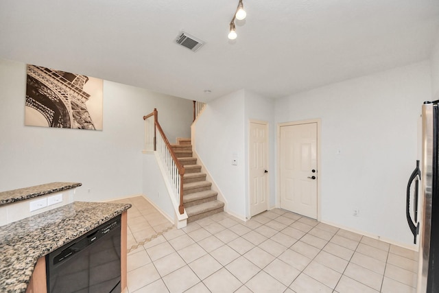 entryway featuring light tile patterned flooring, visible vents, baseboards, and stairs