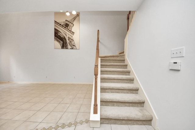 stairway with tile patterned flooring and baseboards