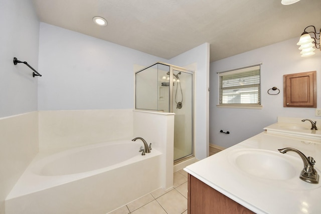 bathroom featuring double vanity, a sink, a shower stall, tile patterned flooring, and a bath