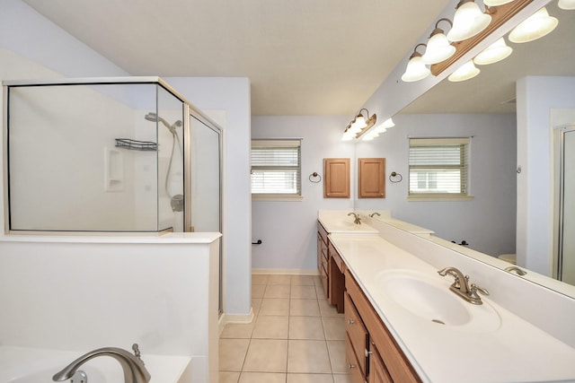 bathroom with plenty of natural light, tile patterned flooring, a sink, and double vanity