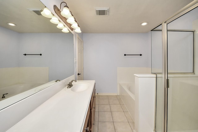 bathroom with visible vents, a garden tub, vanity, and tile patterned floors