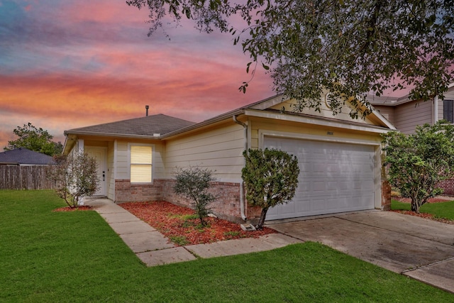 ranch-style house with driveway, brick siding, an attached garage, and a yard