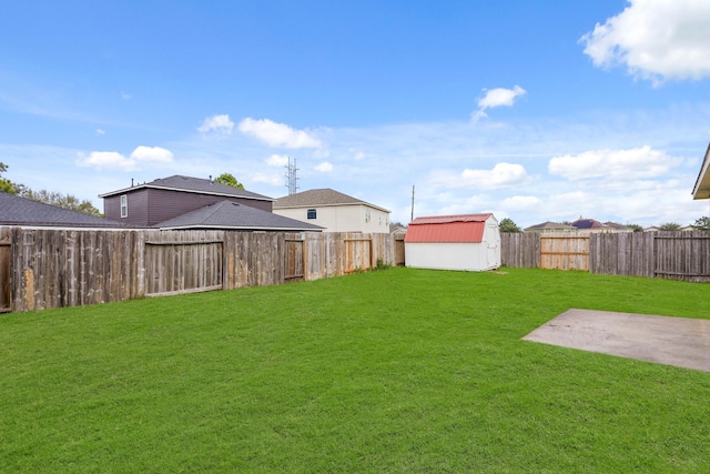 view of yard featuring a patio area, a fenced backyard, an outdoor structure, and a shed