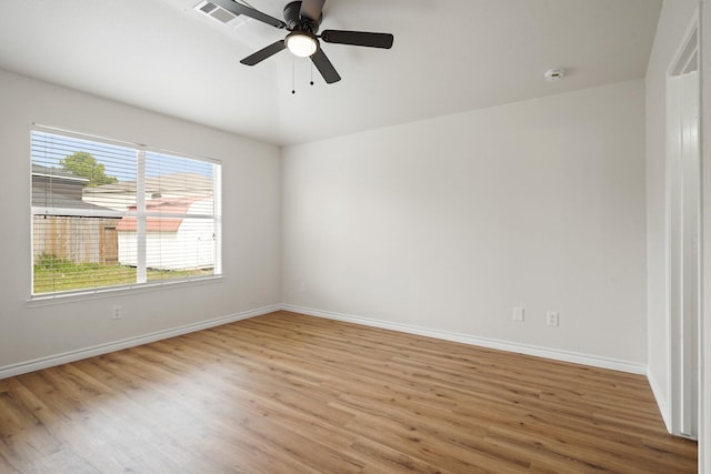 empty room with light wood-type flooring, baseboards, visible vents, and a ceiling fan