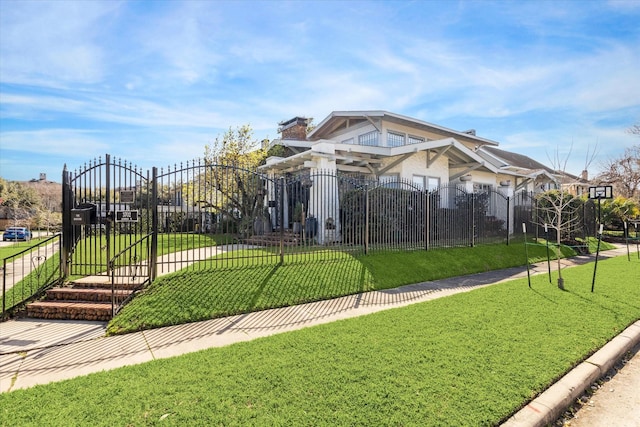 view of home's community with a yard, a fenced front yard, and a gate