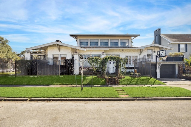 view of front of home featuring driveway, a fenced front yard, a front yard, and a balcony