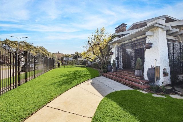 exterior space featuring entry steps, fence private yard, and a lawn