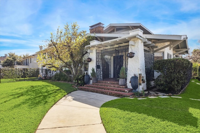 view of front of house featuring fence, a chimney, and a front lawn