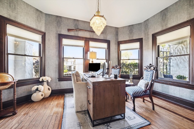 office space with baseboards, hardwood / wood-style floors, a chandelier, and wallpapered walls