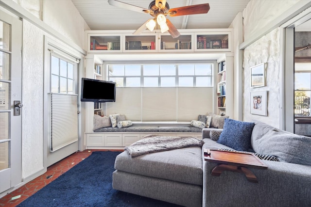 living room featuring ceiling fan and brick floor