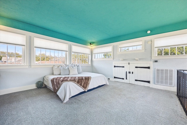 carpeted bedroom featuring baseboards, multiple windows, and visible vents