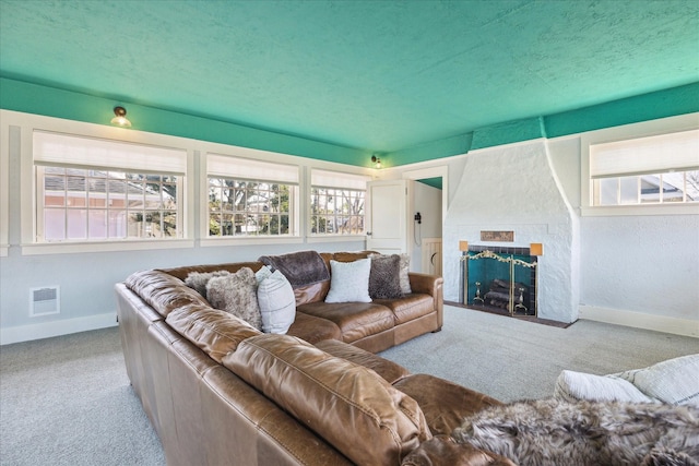 3702 Audubon Pl, Houston, TX 77006 - living room featuring carpet floors, baseboards, and a large fireplace