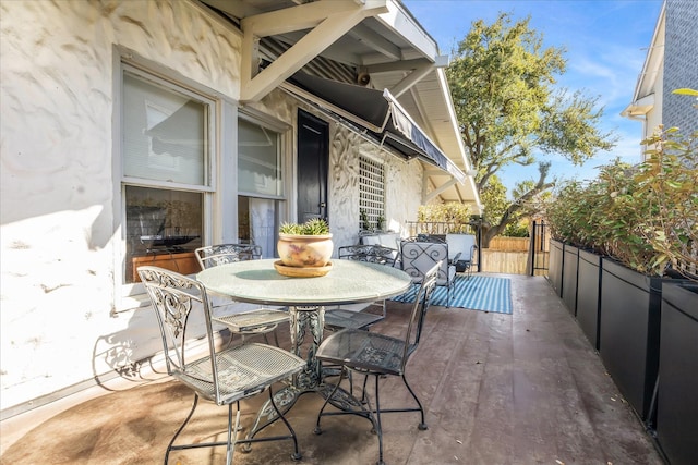 view of patio featuring outdoor dining area and fence