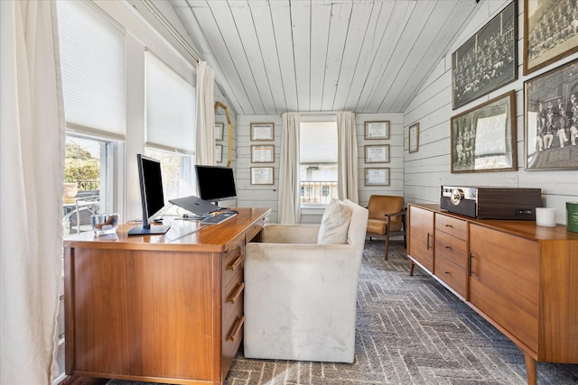 office space with lofted ceiling, wood walls, brick floor, and wood ceiling