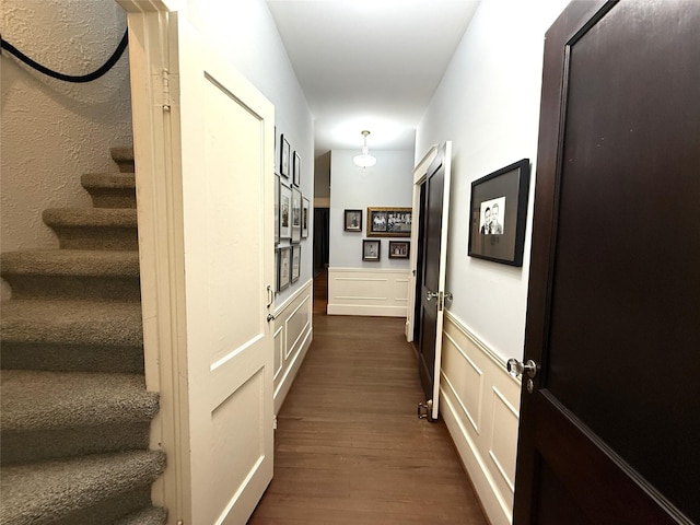 hallway with stairs and dark wood-type flooring