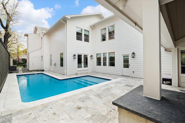 view of swimming pool featuring a patio area, fence, and a fenced in pool