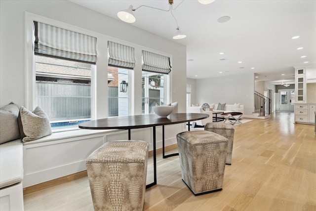 dining room with light wood-style floors, recessed lighting, stairway, and baseboards