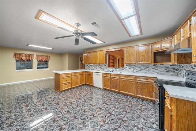 kitchen with under cabinet range hood, backsplash, dishwasher, visible vents, and black electric range