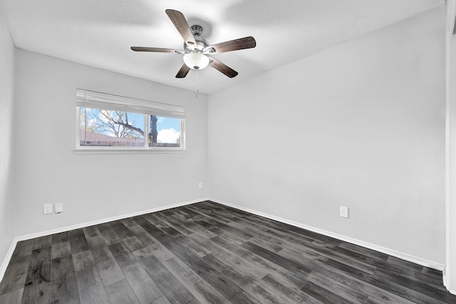 unfurnished room with dark wood-style flooring, a ceiling fan, and baseboards