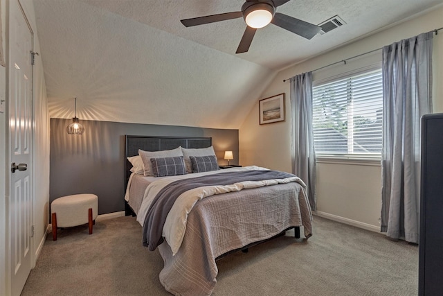 bedroom with lofted ceiling, a textured ceiling, carpet flooring, visible vents, and baseboards