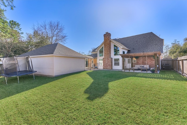 rear view of house with a chimney, an outdoor hangout area, a trampoline, a yard, and a pergola