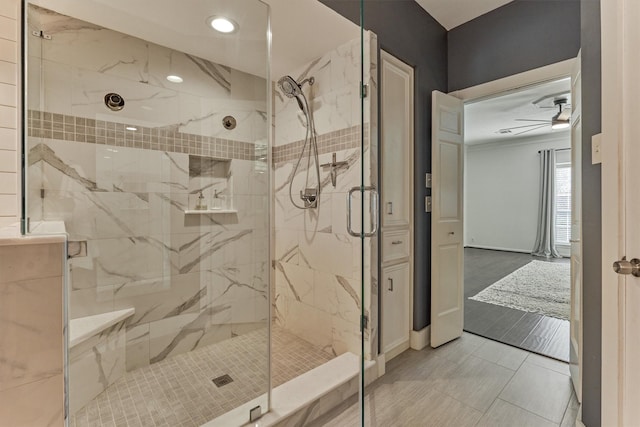 full bath featuring ceiling fan, recessed lighting, a marble finish shower, and baseboards