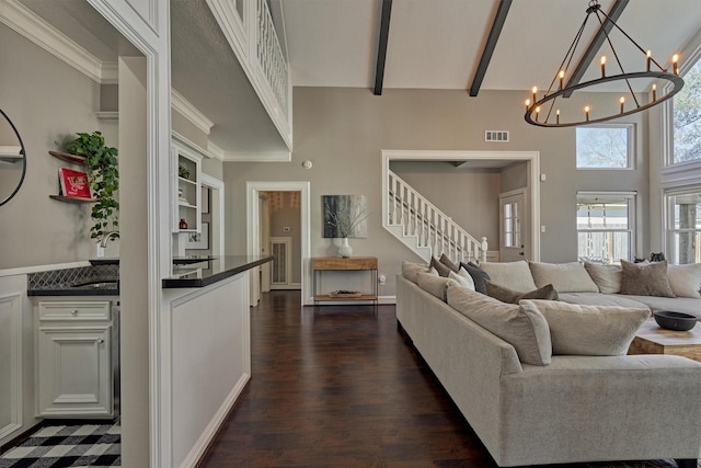 living room featuring dark wood-style flooring, visible vents, high vaulted ceiling, beamed ceiling, and stairs