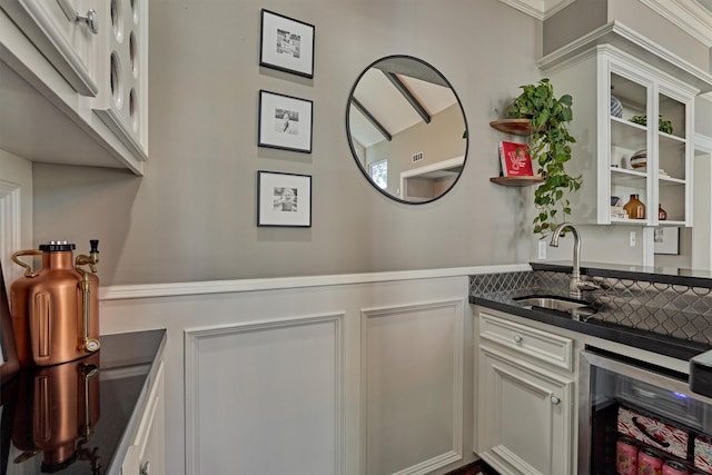 bar featuring wine cooler, a sink, and wet bar