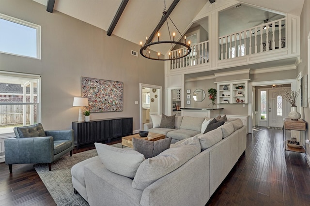 living area with visible vents, dark wood-type flooring, an inviting chandelier, high vaulted ceiling, and beam ceiling