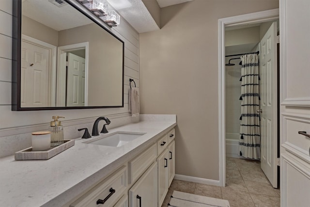 bathroom with tile patterned floors, shower / bath combo, baseboards, and vanity