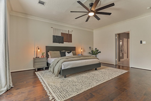 bedroom featuring ornamental molding, dark wood-style flooring, visible vents, and baseboards