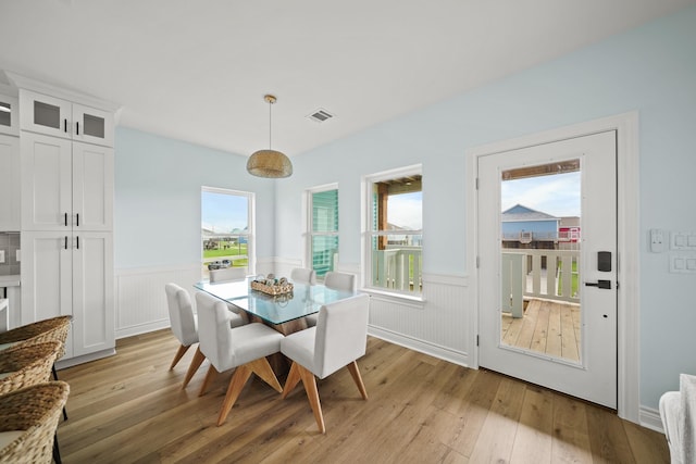 4411 Ranger Dr, Crystal Beach, TX 77650 - dining room featuring wainscoting and light wood-style floors
