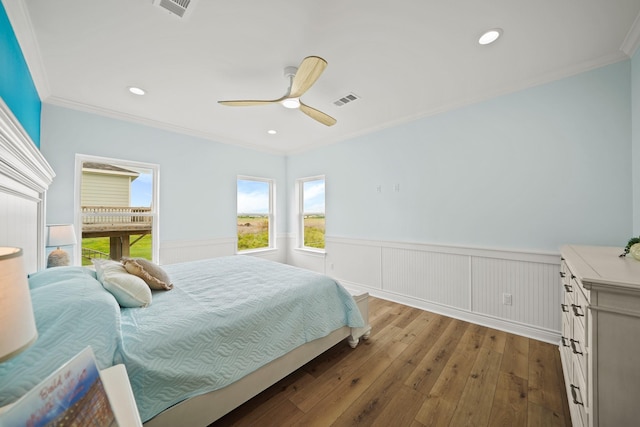 4411 Ranger Dr, Crystal Beach, TX 77650 - bedroom featuring wainscoting, ornamental molding, wood-type flooring, ceiling fan, and recessed lighting