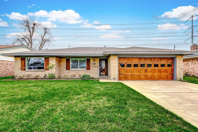 view of front of home featuring brick siding, roof with shingles, a front yard, a garage, and driveway