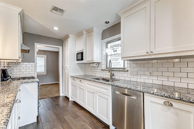 kitchen featuring black microwave, a sink, visible vents, stainless steel dishwasher, and dark wood-style floors