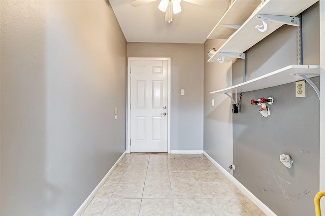 laundry room featuring light tile patterned floors, laundry area, a ceiling fan, and baseboards