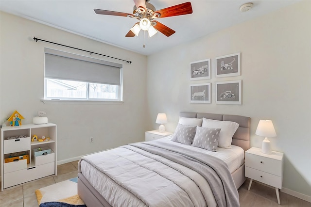 bedroom featuring light tile patterned floors, baseboards, and a ceiling fan