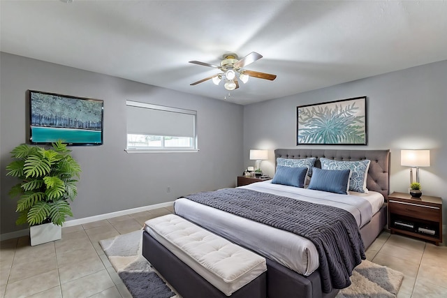 bedroom with light tile patterned floors, ceiling fan, and baseboards