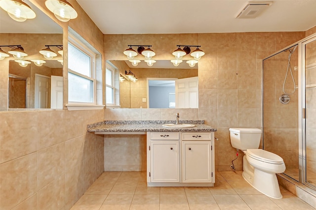 full bathroom featuring a shower stall, visible vents, tile walls, and tile patterned floors