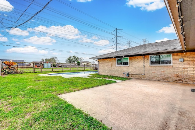 view of yard featuring a patio area, fence, and a fenced in pool