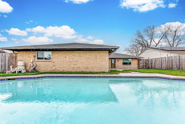 view of pool with a fenced in pool and fence