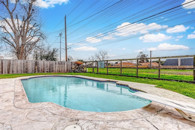 view of swimming pool with a patio, a lawn, a fenced backyard, and a fenced in pool