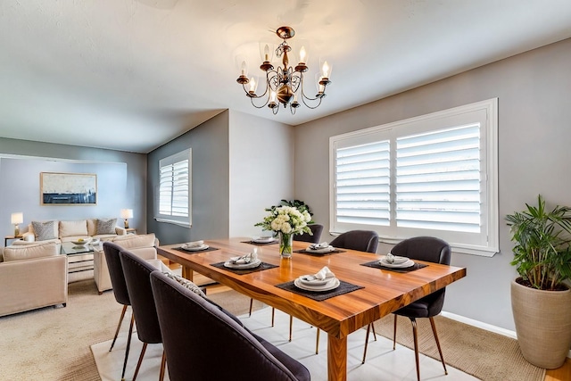 dining space with a notable chandelier and baseboards