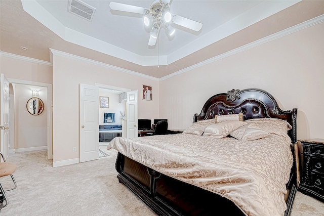 bedroom with a raised ceiling, visible vents, light carpet, and baseboards