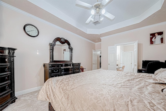 carpeted bedroom with visible vents, baseboards, a raised ceiling, ceiling fan, and crown molding